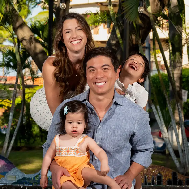 Family with young children playing on the sand during a beach session in Puerto Vallarta